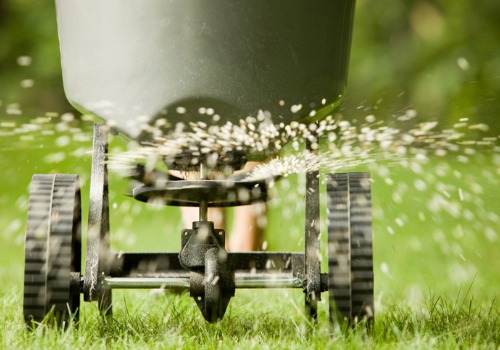 Someone spreading Lawn Fertilizer in Peoria IL